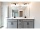 Bathroom features a double sink vanity, large mirror, and modern lighting fixtures at 125 Priestwood Ln, Acworth, GA 30102