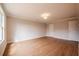 Large bedroom featuring wood-look floors, neutral walls, and a light fixture at 125 Priestwood Ln, Acworth, GA 30102