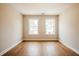 Bright and airy room featuring hardwood floors and two windows offering neighborhood views at 125 Priestwood Ln, Acworth, GA 30102