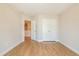 Bright bedroom with hardwood floors, double door closet, and an open doorway at 125 Priestwood Ln, Acworth, GA 30102