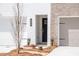 Exterior features of a new townhome with stone accents, a dark front door and two car garage at 125 Priestwood Ln, Acworth, GA 30102