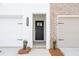 New townhome exterior with stone accents, a dark front door and a two-car garage at 125 Priestwood Ln, Acworth, GA 30102
