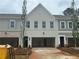 New construction townhomes with gray and white brick and siding exteriors and two car garages at 125 Priestwood Ln, Acworth, GA 30102