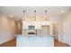 New kitchen with white cabinets, stainless appliances, granite countertops, gray island and wood flooring at 125 Priestwood Ln, Acworth, GA 30102