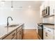 Kitchen and adjoining rooms featuring stainless steel appliances, granite countertops, and recessed lighting at 125 Priestwood Ln, Acworth, GA 30102