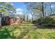 Spacious, partially shaded backyard with mature trees and ample room for recreation at 1286 Calhoun Sw Ter, Atlanta, GA 30314