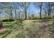 Spacious backyard featuring lush grass, mature trees and beautiful scenery at 1286 Calhoun Sw Ter, Atlanta, GA 30314