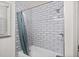 Bathroom shower featuring white subway tile and shower curtain at 1286 Calhoun Sw Ter, Atlanta, GA 30314
