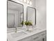 Bathroom featuring a dual sink vanity with modern fixtures and decorative mirrors at 1286 Calhoun Sw Ter, Atlanta, GA 30314