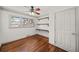 Bedroom featuring hardwood floors, a ceiling fan, built-in shelving and natural light at 1286 Calhoun Sw Ter, Atlanta, GA 30314
