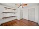 Bedroom featuring hardwood floors, ceiling fan, built-in shelving and natural light at 1286 Calhoun Sw Ter, Atlanta, GA 30314
