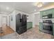 Well-lit kitchen with stainless steel refrigerator and view into the adjoining hall at 1286 Calhoun Sw Ter, Atlanta, GA 30314
