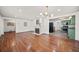 Open-concept living room with hardwood floors, a fireplace, and seamless access to the kitchen at 1286 Calhoun Sw Ter, Atlanta, GA 30314