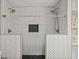 Modern bathroom shower featuring stylish herringbone tile and a convenient built-in niche at 1286 Calhoun Sw Ter, Atlanta, GA 30314
