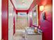Stylish bathroom with red walls, granite countertop vanity, and a tub with a shower at 1820 Buckhead Valley Ne Ln, Atlanta, GA 30324