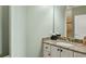 Bathroom vanity featuring granite countertop, white cabinetry, and a decorative mirror at 1820 Buckhead Valley Ne Ln, Atlanta, GA 30324