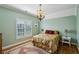 Comfortable bedroom with hardwood flooring, plantation shutters, and a decorative chandelier at 1820 Buckhead Valley Ne Ln, Atlanta, GA 30324