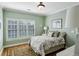 Relaxing bedroom boasts natural light, a decorative rug, and soothing green walls at 1820 Buckhead Valley Ne Ln, Atlanta, GA 30324