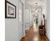 Bright hallway featuring hardwood floors, white trim, and decorative lighting fixtures at 1820 Buckhead Valley Ne Ln, Atlanta, GA 30324