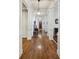 Long hallway featuring hardwood flooring, elegant columns, and decorative lighting fixtures at 1820 Buckhead Valley Ne Ln, Atlanta, GA 30324