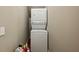 Compact laundry room with stackable washer and dryer, maximizing space efficiency at 1820 Buckhead Valley Ne Ln, Atlanta, GA 30324