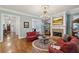 Elegant living room with hardwood floors, fireplace, and ornate chandelier, perfect for entertaining guests at 1820 Buckhead Valley Ne Ln, Atlanta, GA 30324