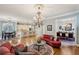 Spacious living room featuring a chandelier, open layout to kitchen and dining, and hardwood floors at 1820 Buckhead Valley Ne Ln, Atlanta, GA 30324