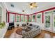 Bright sunroom with large windows, wood floors, ceiling fans, and comfortable seating for relaxing and entertaining at 1820 Buckhead Valley Ne Ln, Atlanta, GA 30324