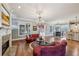 Open-concept living space with fireplace, hardwood floors, and views of the dining area and kitchen at 1820 Buckhead Valley Ne Ln, Atlanta, GA 30324