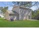 View of backyard of home featuring a large grassy area with a concrete patio at 2143 Victoria Pl, Lithonia, GA 30058
