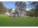 Back exterior featuring a well-maintained lawn and a two-story home with neutral siding at 2143 Victoria Pl, Lithonia, GA 30058