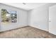 Bedroom boasts neutral walls, carpeted floors, and a window overlooking the neighborhood at 2143 Victoria Pl, Lithonia, GA 30058