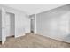 Bedroom with neutral walls, carpeted floors, closet door, and hallway entry at 2143 Victoria Pl, Lithonia, GA 30058