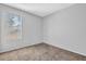 Bedroom showcases neutral walls, carpeted floors, and a large window for natural light at 2143 Victoria Pl, Lithonia, GA 30058