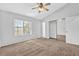 Spacious bedroom with neutral carpet, ceiling fan, and a closet at 2143 Victoria Pl, Lithonia, GA 30058