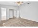 A bright bedroom features carpeted floors, ceiling fan, and a closet with sliding doors at 2143 Victoria Pl, Lithonia, GA 30058