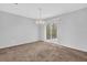 Bright dining area with sliding glass doors to the backyard, neutral carpet, and modern lighting at 2143 Victoria Pl, Lithonia, GA 30058