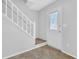 Welcoming entryway with staircase and glass-paneled front door, featuring light neutral walls at 2143 Victoria Pl, Lithonia, GA 30058