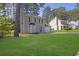 Traditional two-story home boasts a well-manicured lawn and attached single car garage at 2143 Victoria Pl, Lithonia, GA 30058