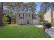 Charming two-story home featuring a landscaped yard, attached garage and large front windows at 2143 Victoria Pl, Lithonia, GA 30058