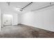 Spacious garage with concrete floors, access to the laundry, and a door for entry at 2143 Victoria Pl, Lithonia, GA 30058
