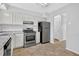 Modern kitchen with stainless steel appliances, white cabinets and granite countertops at 2143 Victoria Pl, Lithonia, GA 30058