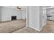 Open concept living room with fireplace, ceiling fan, and views to the kitchen at 2143 Victoria Pl, Lithonia, GA 30058