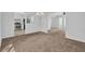Spacious living room featuring neutral carpet, paint, and fixtures with an adjoining kitchen at 2143 Victoria Pl, Lithonia, GA 30058