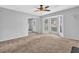 Sunlit living room features a bay window, fireplace, and neutral carpet at 2143 Victoria Pl, Lithonia, GA 30058