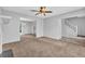 Spacious living room with fireplace, staircase, and open view to the dining and kitchen areas at 2143 Victoria Pl, Lithonia, GA 30058