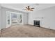 Bright and airy living room with fireplace, large windows, and neutral colored carpet at 2143 Victoria Pl, Lithonia, GA 30058