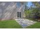 Grassy backyard featuring a concrete patio area, perfect for outdoor seating and entertainment at 2143 Victoria Pl, Lithonia, GA 30058