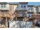 View of a townhouse backyard with a wooden fence and elevated wooden decks on the back of the property at 3182 Mill Springs Cir, Buford, GA 30519