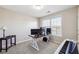 Neutral-toned bedroom with large window, offering a functional workspace with dual monitors and piano at 3182 Mill Springs Cir, Buford, GA 30519